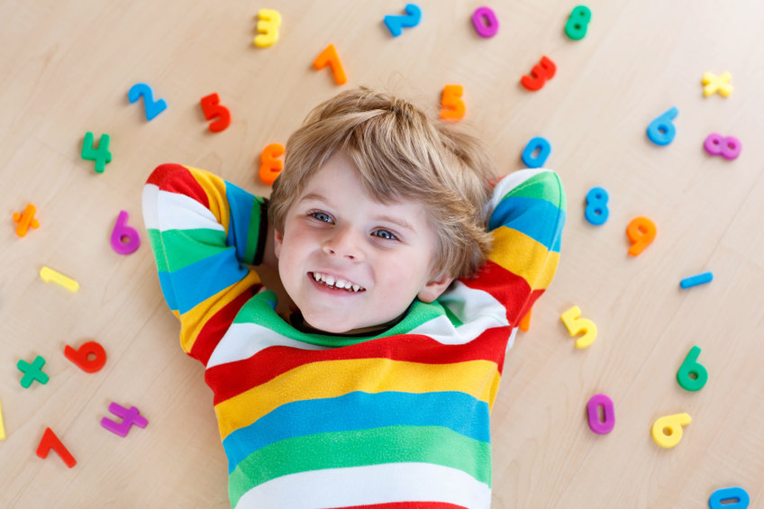 Kid boy with colorful numbers, indoor
